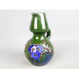 Elton Studio Ware - a jug with floral decoration on a green ground,