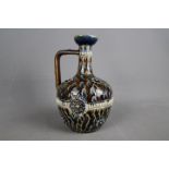 A late Victorian Doulton Lambeth stoneware jug with slender neck and angular handle,