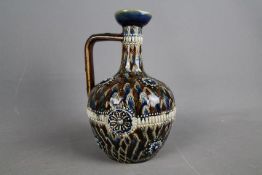 A late Victorian Doulton Lambeth stoneware jug with slender neck and angular handle,