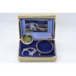 A vintage jewellery box containing a hallmarked silver bangle with safety chain,