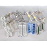 A good collection of white metal and glass knife rests.