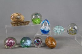 Seven paperweights to include Millrace, Caithness and similar, stone eggs and other.