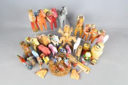 A collection of treen comprising Dalecarlian / Dala horses, Russian nesting dolls and similar.