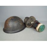 A World War Two (WWII) gas mask by B. W. & M. Ltd and a British Mk IV 'Turtle' helmet.