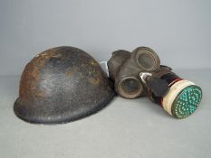 A World War Two (WWII) gas mask by B. W. & M. Ltd and a British Mk IV 'Turtle' helmet.