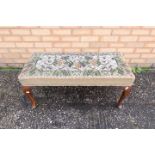 An upholstered rectangular stool with mahogany cabriole supports,