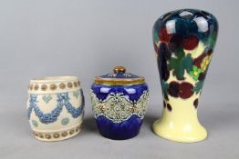 Royal Doulton, Doulton Lambeth - Two stoneware tobacco jars,