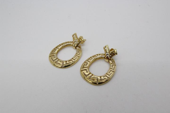 A pair of yellow metal earrings presumed gold (unmarked) with one of the butterfly clasps stamped