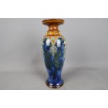 A Royal Doulton stoneware vase, stylised floral decoration in relief against a mottled blue ground,