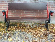 A garden bench seat with wooden planked back and seat,