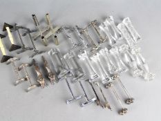 A good selection of sixteen pairs of knife rests to include cut glass, plated,