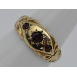 A 9ct gold and garnet, three stone gypsy set ring, size L, approximately 2.5 grams all in.