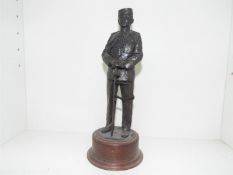 A cold cast bronze figurine depicting a uniformed military figure mounted on a plinth,