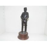 A cold cast bronze figurine depicting a uniformed military figure mounted on a plinth,