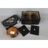 An Edwardian black lacquered tea caddy with inset mother of pearl decoration,