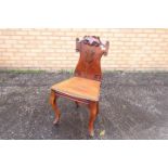 An early 19th century mahogany hall chair,