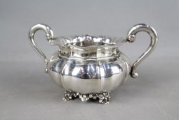 A silver twin-handled bowl raised on four scrolled supports, impressed import marks to the base,