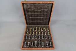 A metal 'Crusades' chess set contained in fitted box, king approximately 6 cm (h).