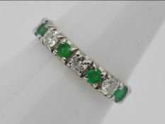 An 18ct white gold, emerald and diamond, half eternity ring, size K, approximately 1.5 grams all in.