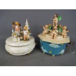 Two Erzgebirge hand painted wooden music boxes.