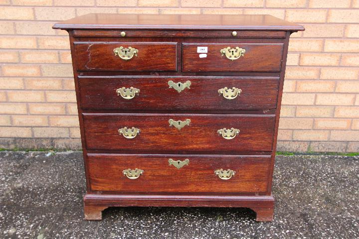 Chest of drawers - a George III mahogany chest of two over three drawers,