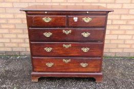 Chest of drawers - a George III mahogany chest of two over three drawers,