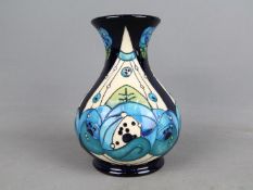 Moorcroft Pottery - a large vase with flared rim decorated in the Rennie Rose Blue pattern,