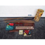 A collection of snooker cues, scoreboards, snooker balls, cue rack and similar.