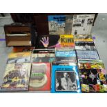 A collection of 12" vinyl records to include Elton John, The Kinks, Deep Purple, George Harrison,
