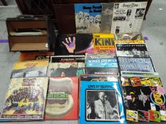 A collection of 12" vinyl records to include Elton John, The Kinks, Deep Purple, George Harrison,