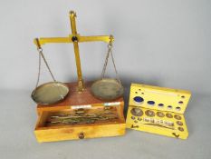 A vintage set of jewellers scales by Arnold Precision Scales, Redhill and a set of weights in case.