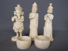 A collection of early 20th century worked ivory and bone to include napkin rings and figurines,