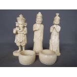 A collection of early 20th century worked ivory and bone to include napkin rings and figurines,