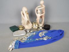 A mixed lot to include two stone sculptures, clocks, belly dancing hip skirt, watches, stud box,