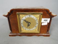 An Elliott mantel clock, brass dial with Roman numerals to a silvered chapter ring.