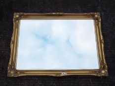 A gilt framed, bevel edged wall mirror, approximately 76 cm x 105 cm.