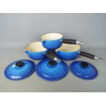 Le Creuset - A set of three cast iron Le Creuset pans in blue with lids marked 16, 18,