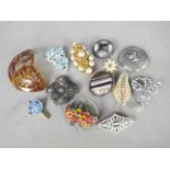 Brooches - Twelve brooches with various designs,