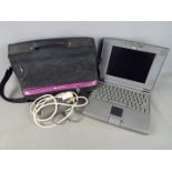 An Apple PowerBook 500 Series, model M4880, with carry bag and power adapter.