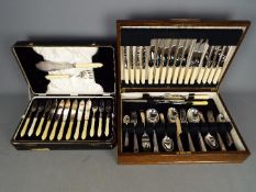 A oak cased canteen of cutlery and a further cased set (2)