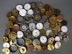 A quantity of pocket watch movements, dials and parts.