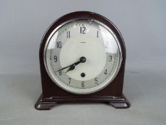 A bakelite cased Enfiled mantel clock with key and pendulum.