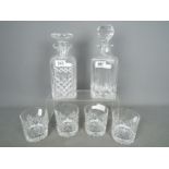 An Edinburgh International Crystal decanter and four tumblers and one further decanter by Stuart