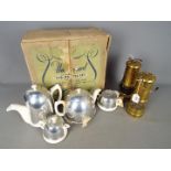 A vintage 'Flo - Hot' tea set contained in original box and two safety lamps,
