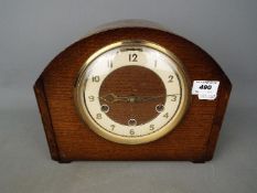 A Smiths mantel clock with key and pendulum.