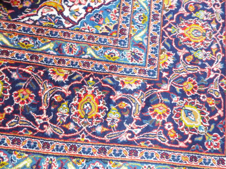 A large red ground Persian Kashan carpet measuring approximately 290 cm x 400 cm - Image 2 of 3