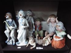 Lot to include Spanish clown figurines and a quantity of piano babies.