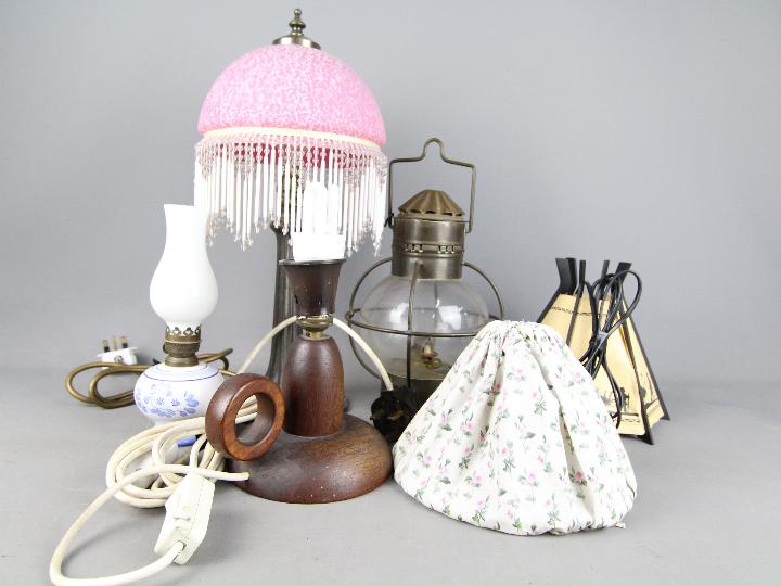 A collection of table lamps, oil lamp, lantern.