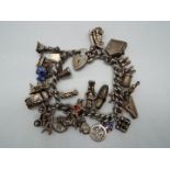 A silver charm bracelet with around 30 silver and white metal charms, approximately 3 toz,