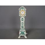 A hand painted green delft miniature longcase clock,